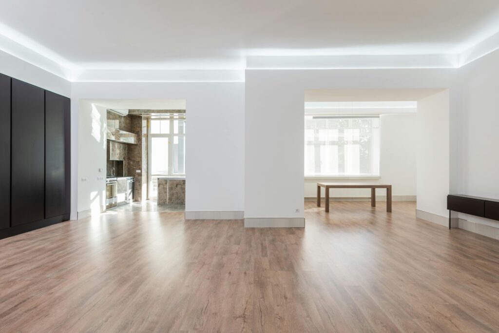 Bright and spacious empty room with wooden flooring, modern design, ideal for interior design inspiration.